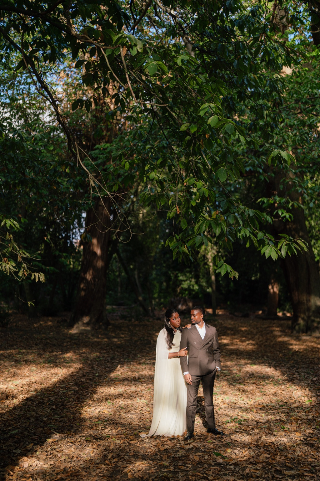 Davina and Peter beneath garden trees
