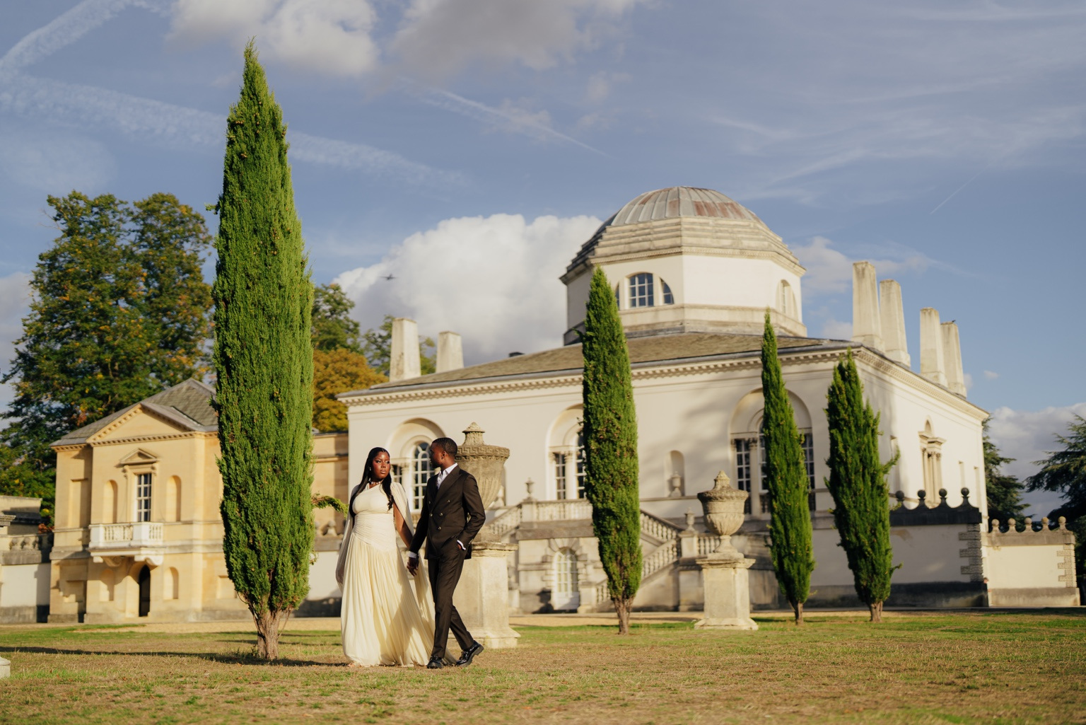 Davina and Peter outside the grand estate